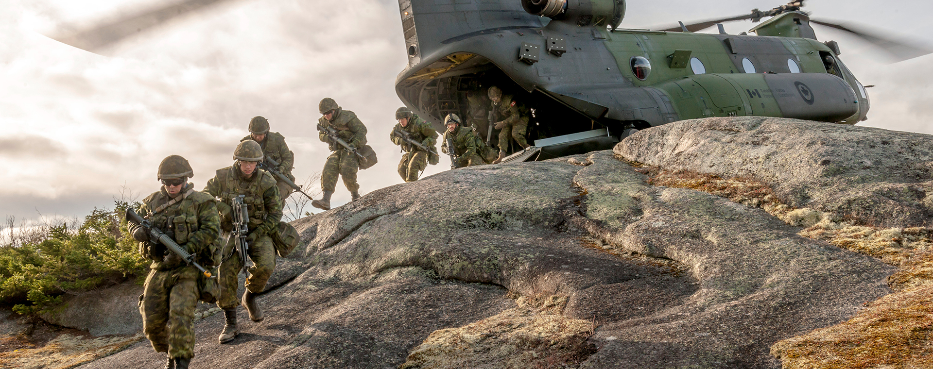 Canadian soldiers disembark from their attack helicopter in single file. Equipped with weapons and combat gear, they are determined, focussed and ready for the many adventures awaiting them in foreign territory.